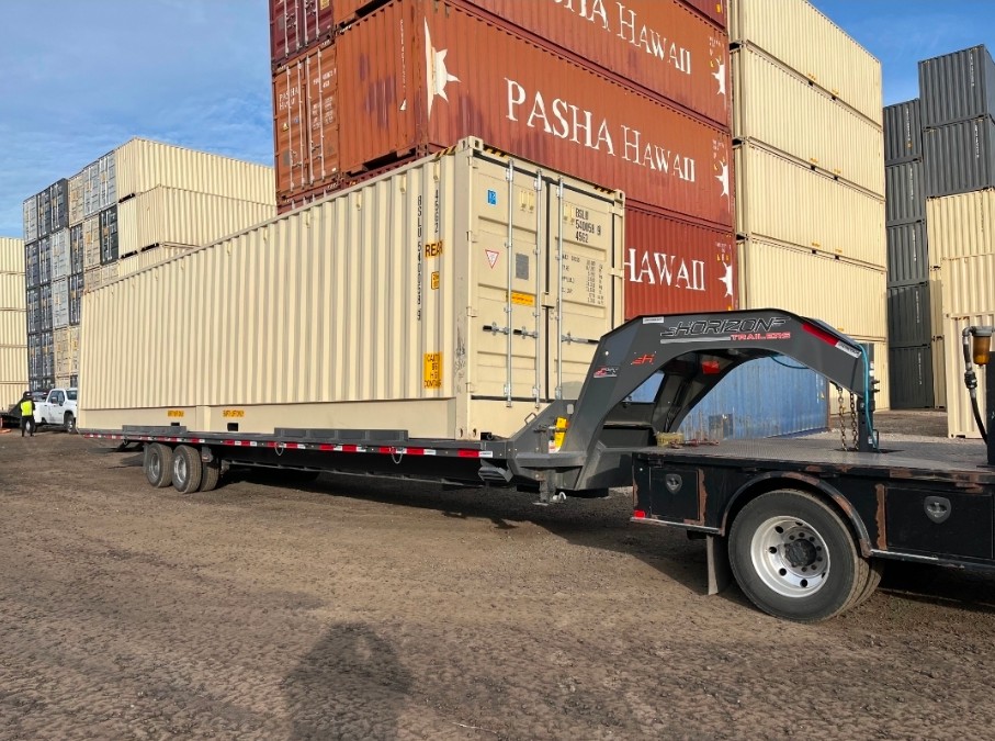 Shipping container secured on a transport trailer at a container yard