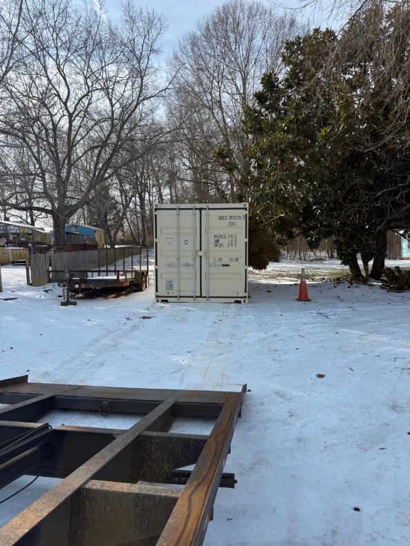 Delivery trailer approach facing a shipping container placement area