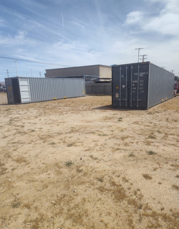 Two shipping containers showing different exterior colors and visible wear